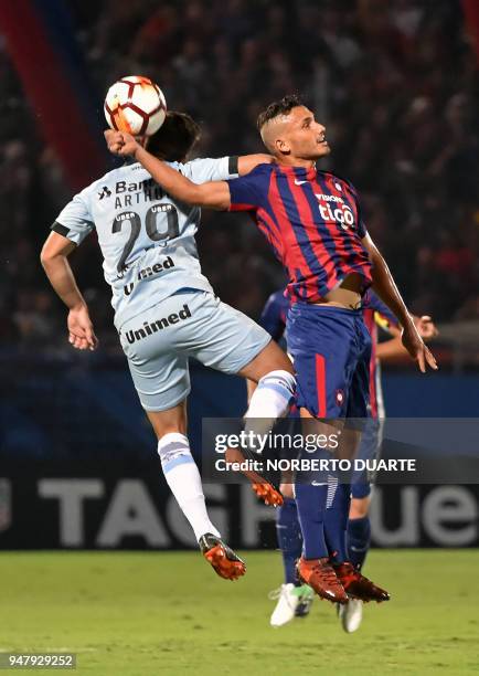 Arthur of Brazils Gremio vies for the ball with Juan Escobar of Paraguay's Cerro Porteno during their Copa Libertadores football match held at Pablo...