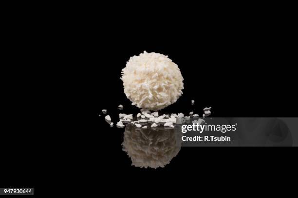 white sweet chocolate, covered the coconut shaving on a dark background - coconut shaving stock pictures, royalty-free photos & images