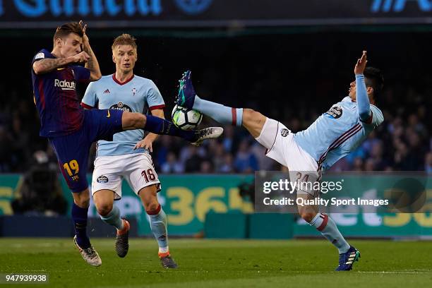 Facundo Roncaglia of Celta de Vigo competes for the ball with Lucas Digne of FC Barcelona during the La Liga match between Celta de Vigo and...