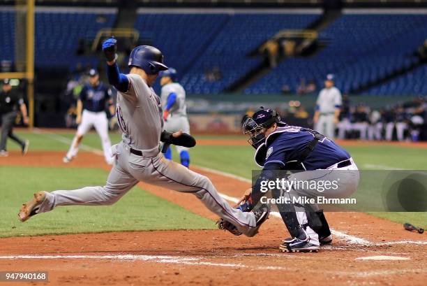 Wilson Ramos of the Tampa Bay Rays tags out Drew Robinson of the Texas Rangers trying to score in the eighth inning during a game at Tropicana Field...