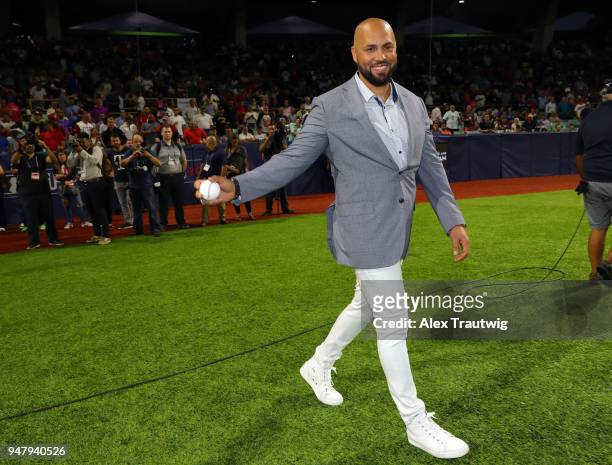 Former MLB Player and Puerto Rico native Carlos Beltran walks onto the field to throw out the ceremonial first pitch during the pregame ceremony...