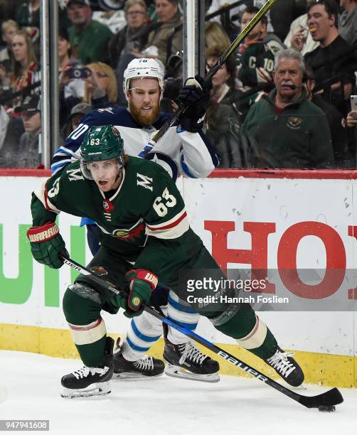 Tyler Ennis of the Minnesota Wild controls the puck against Joe Morrow of the Winnipeg Jets during the second period in Game Four of the Western...