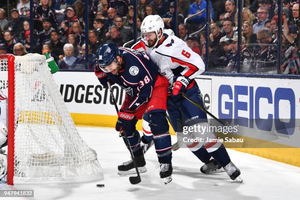 Boone Jenner of the Columbus Blue Jackets battles to keep the puck from Michal Kempny of the Washington Capitals during the third period in Game...