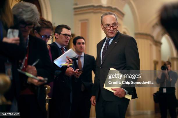 Senate Minority Leader Charles Schumer talks to staff members during the weekly Democratic policy luncheon at the U.S. Capitol April 17, 2018 in...