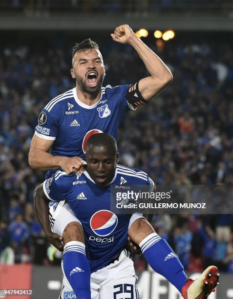 Colombia's Millonarios player Eliser Quinones celebrates with Andres Cadavid after scoring against Venezuela's Deportivo Lara during their Copa...