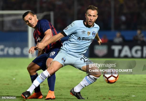Arthur of Brazils Gremio vies for the ball with Jorge Rojas of Paraguay's Cerro Porteno during their Copa Libertadores football match held at Pablo...
