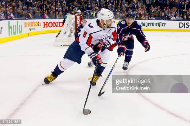 Alex Ovechkin of the Washington Capitals keeps control of the puck away from Zach Werenski of the Columbus Blue Jackets during the third period in...