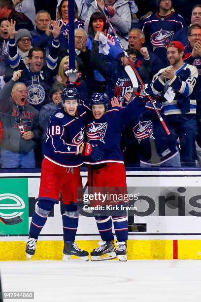 Pierre-Luc Dubois of the Columbus Blue Jackets congratulates Artemi Panarin of the Columbus Blue Jackets after scoring a goal during the third period...