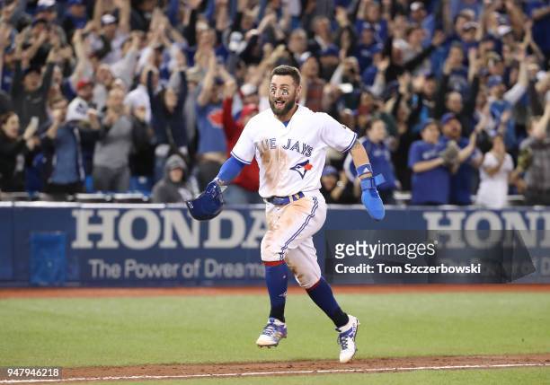 Kevin Pillar of the Toronto Blue Jays celebrates a game-winning RBI single by Luke Maile as he comes to score the winning run in the tenth inning...