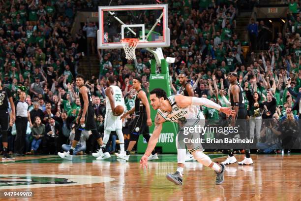 Shane Larkin of the Boston Celtics celebrates hitting a three point buzzer beater to end the third quarter against the Milwaukee Bucks in Game Two of...