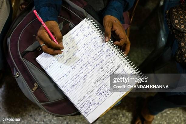 In this photograph taken on April 7 a student writes notes inside a classroom at a tuition centre that prepares candidates for government jobs exams...