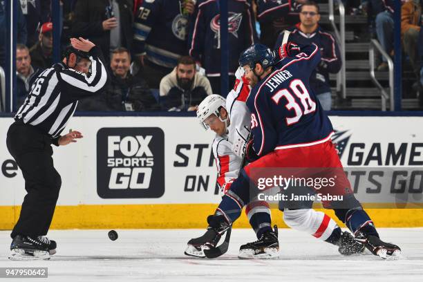 Jay Beagle of the Washington Capitals and Boone Jenner of the Columbus Blue Jackets battle for a loose puck following a face-off during the first...