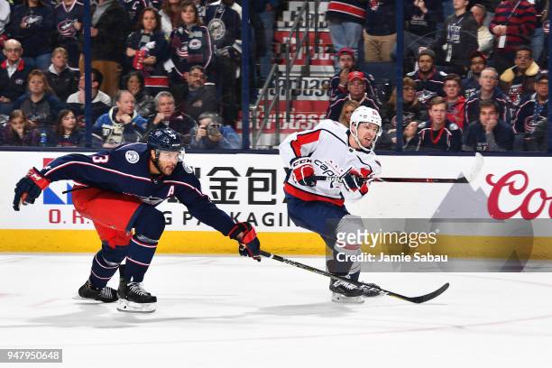 Evgeny Kuznetsov of the Washington Capitals shoots the puck past the reaching stick of Seth Jones of the Columbus Blue Jackets during the first...