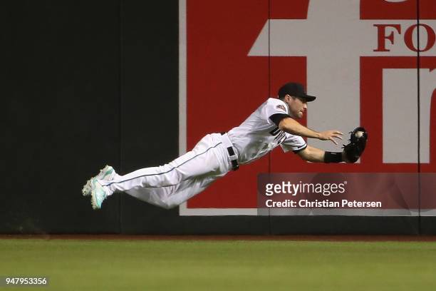 Outfielder A.J. Pollock of the Arizona Diamondbacks makes a diving catch for an out against the San Francisco Giants during the sixth inning of the...