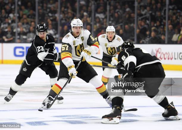 David Perron of the Vegas Golden Knights makes a pass between Jake Muzzin and Dustin Brown of the Los Angeles Kings during the first period in Game...