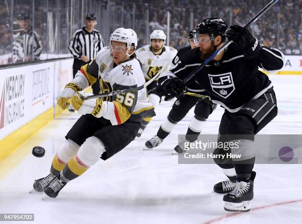 Erik Haula of the Vegas Golden Knights shoots the puck along the boards in front of Jake Muzzin of the Los Angeles Kings during the first period in...