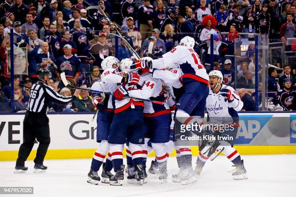 Lars Eller of the Washington Capitals is congratulated by his teammates after scoring the game winning goal against the Columbus Blue Jackets in...