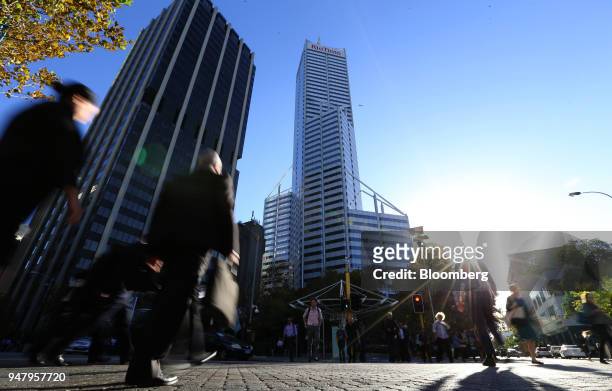 Pedestrians cross an intersection in front of Central Park Tower, center, in the central business district of Perth, Australia, on Wednesday, April...