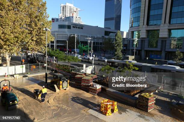 Construction workers repave an area of the central business district of Perth, Australia, on Wednesday, April 11, 2018. Australia is scheduled to...