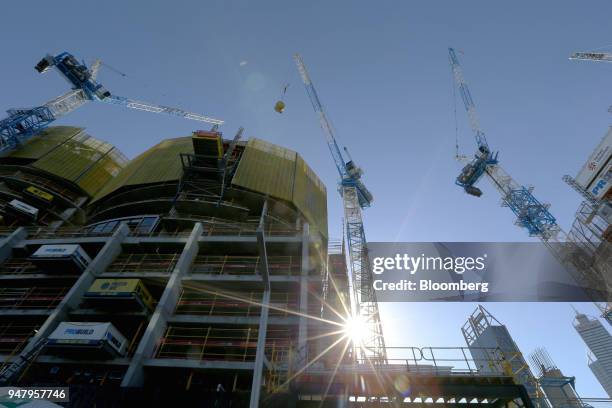 Cranes operate at a construction site in the Elizabeth Quay area of Perth, Australia, on Wednesday, April 11, 2018. Australia is scheduled to release...