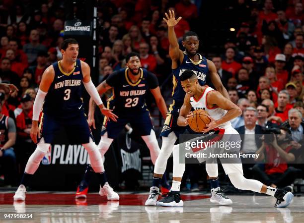 McCollum of the Portland Trail Blazers is guarded by Ian Clark of the New Orleans Pelicans during Game One of the Western Conference Quarterfinals...