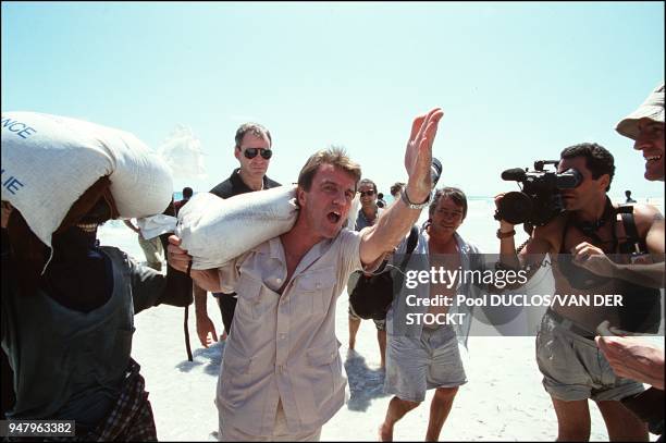 French Minister of health, Bernard Kouchner, participated in the unloading of bags of rice sent by French school children to help local population,...