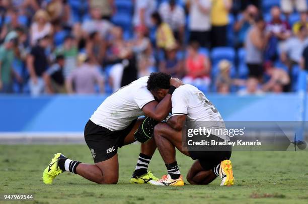 Jerry Tuwai of Fiji is dejected as he is comforted by team mate Vatemo Ravouvou after their team loses the MenÕs Gold Medal Final match between Fiji...