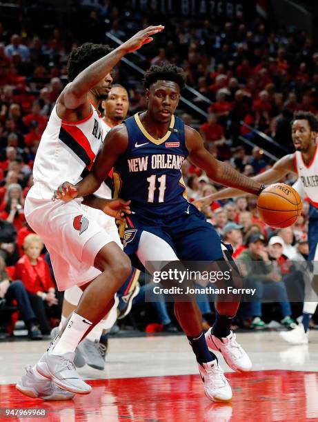 Jrue Holiday of the New Orleans Pelicans drives against Ed Davis of the Portland Trail Blazers during Game One of the Western Conference...