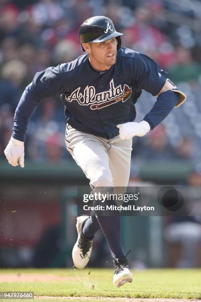 Peter Bourjos of the Atlanta Braves runs to first base during a baseball game against the Washington Nationals at Nationals Park on April 11, 2018 in...