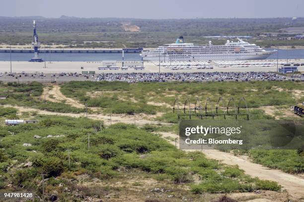 The MS Amadea cruise ship, owned by Amadea Shipping Co. And operated by Phoenix Reisen GmbH, sits moored as vehicles sit parked in lots at Hambantota...