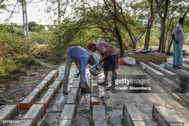 Workers cast concrete for elephant fencing outside the District General Hospital in Hambantota, Sri Lanka, on Wednesday, March 28, 2018. Former Sri...