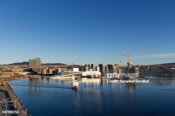 view of the oslo operahouse and river front area of bjørvika - sunphol stock pictures, royalty-free photos & images