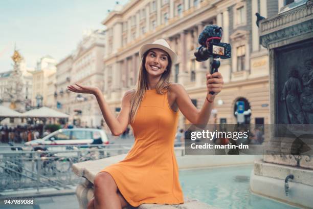 attractive woman vlogging from vienna - blogger woman stock pictures, royalty-free photos & images