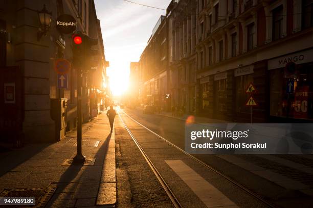 a sunset view between the cityscape along kongens gate in oslo - sunphol stock pictures, royalty-free photos & images