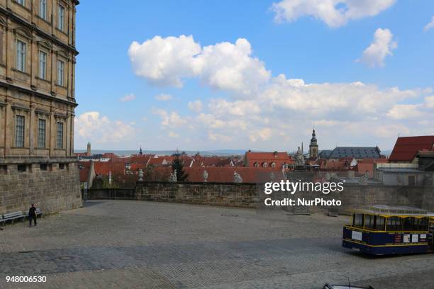 The blue and white sky and some roof are seen on a sunny and hot spring day in Bamberg, Northern Bavaria, Germany. The in Germany will be close to 30...