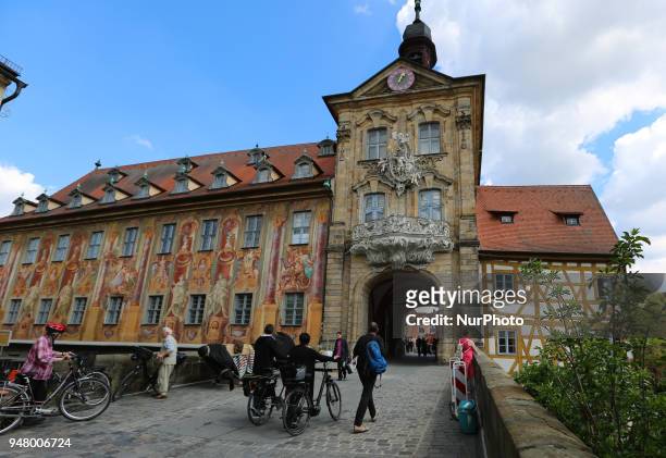 People walking on a sunny and hot spring day in Bamberg, Northern Bavaria, Germany. The in Germany will be close to 30 degrees Celsius the next days.