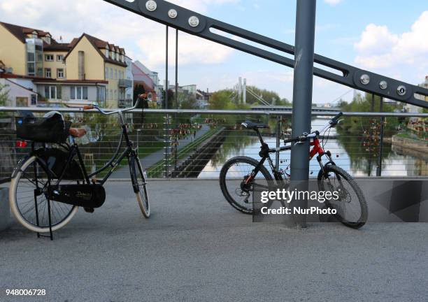 Two bikes stand on a bridge on a sunny and hot spring day in Bamberg, Northern Bavaria, Germany. The in Germany will be close to 30 degrees Celsius...