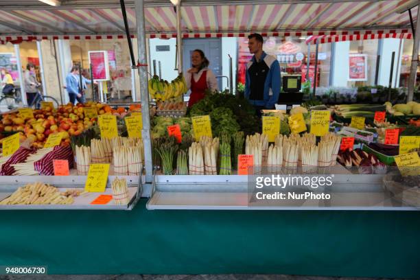 Stand selling fruit and vegetables and especially asparagus is seen on a sunny and hot spring day in Bamberg, Northern Bavaria, Germany. The in...