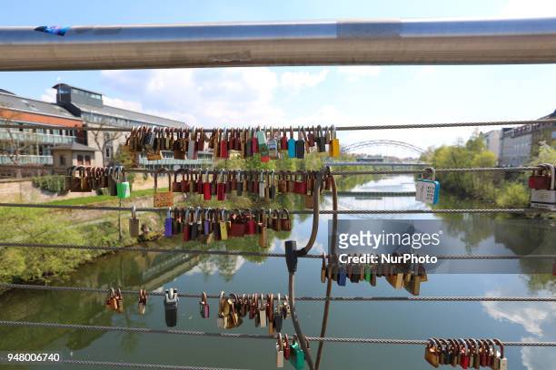 Some padlocks are seen on a bridge on a sunny and hot spring day in Bamberg, Northern Bavaria, Germany. The in Germany will be close to 30 degrees...