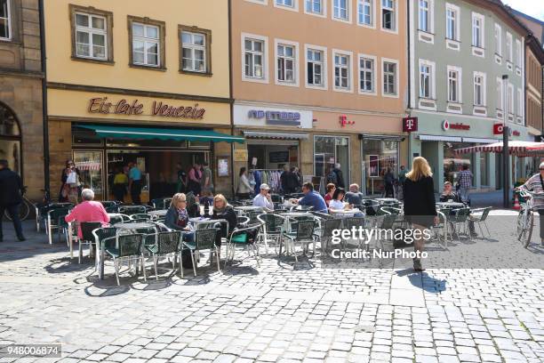 People eating ice cream on a sunny and hot spring day in Bamberg, Northern Bavaria, Germany. The in Germany will be close to 30 degrees Celsius the...