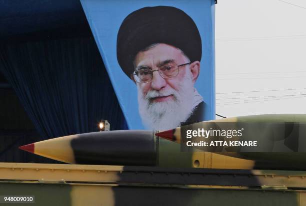 An Iranian military truck carries surface-to-air missiles past a portrait of Iran's Supreme Leader Ayatollah Ali Khamenei during a parade on the...
