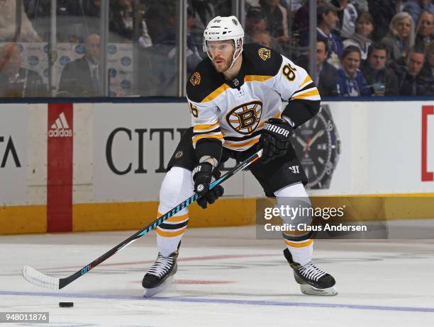 Kevan Miller of the Boston Bruins skates with the puck against the Toronto Maple Leafs in Game Three of the Eastern Conference First Round during the...