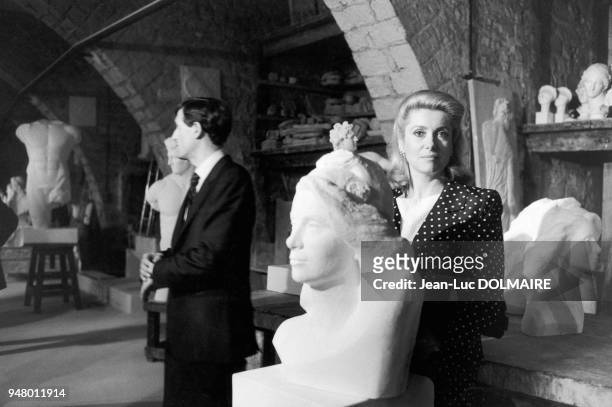 The French actress Catherine DENEUVE, chosen to give her face to MARIANNE, the symbol of the Republic, standing before the bust of Mireille POLSKA...