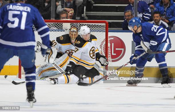 Torey Krug of the Boston Bruins blocks a puck from Connor Brown of the Toronto Maple Leafs in Game Three of the Eastern Conference First Round during...