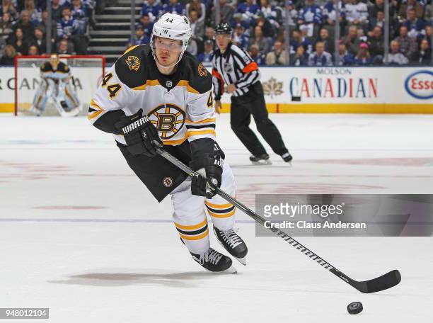 Nick Holden of the Boston Bruins skates with the puck against the Toronto Maple Leafs in Game Three of the Eastern Conference First Round during the...