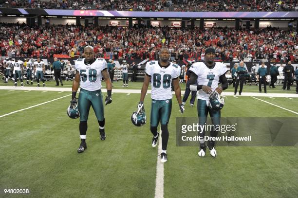 Defensive end Trent Cole, wide receiver Reggie Brown and quarterback Michael Vick of the Philadelphia Eagles walk out for the coin toss during the...