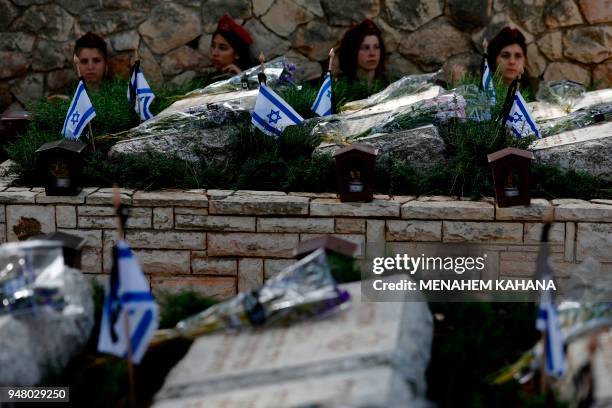 Israeli soldiers visit the graves of their fallen comrades during a Remembrance Day ceremony commemorating Israel's fallen soldiers at the Mount...