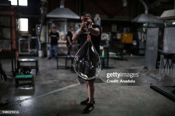 Turkish glassblower Mustafa Dalkilic shapes a piece at Glass House Association's workshop in Riva district of Istanbul, Turkey on April 11, 2018....