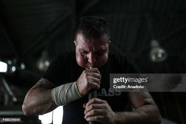 Turkish glassblower Mustafa Dalkilic shapes a piece at Glass House Association's workshop in Riva district of Istanbul, Turkey on April 11, 2018....