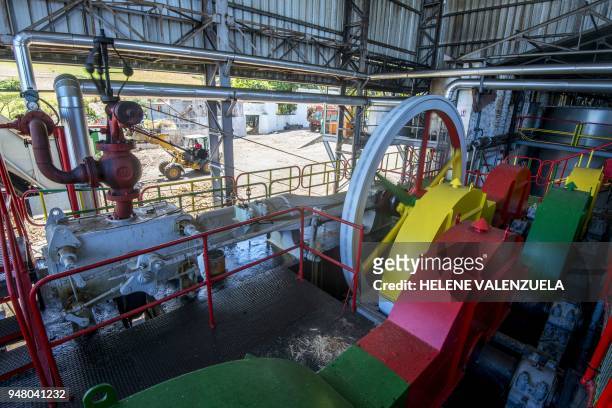 Photo taken on April 12, 2018 shows a mechanical press to extracts sugarcane juice at the Bologne Rum Distillery in Basse-Terre, in the French...